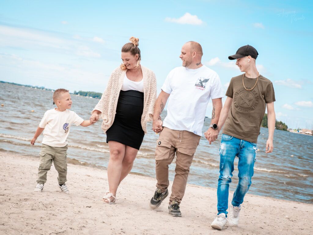 Familie loopt over het strand